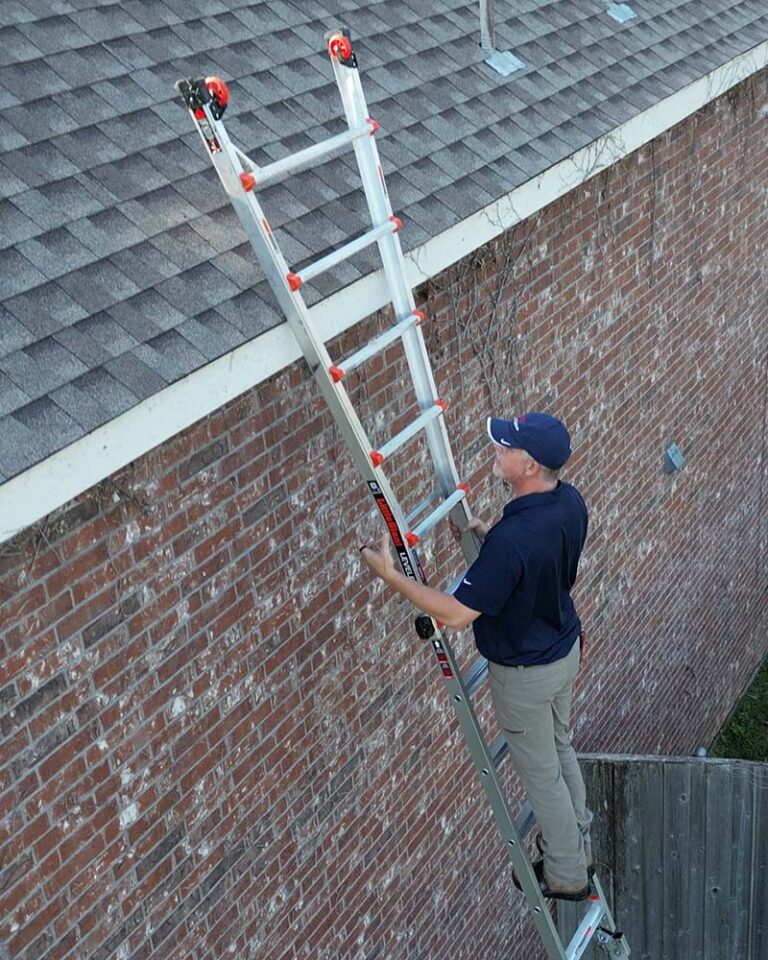 A man on a ladder on the side of a house.