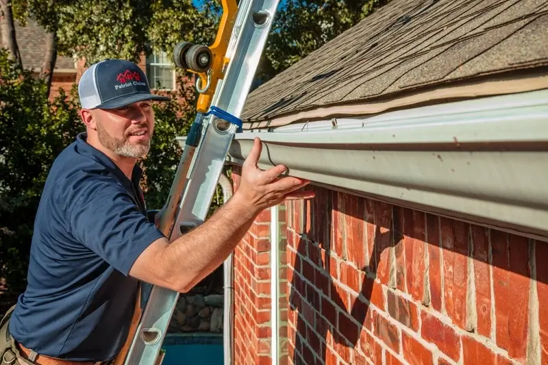 Patriot Claims ladder assist inspector on residential roof providing safe access for damage documentation